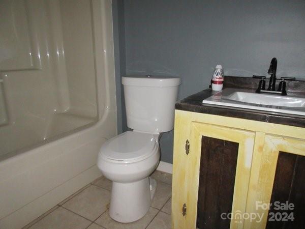 bathroom featuring tile patterned floors, vanity, and toilet