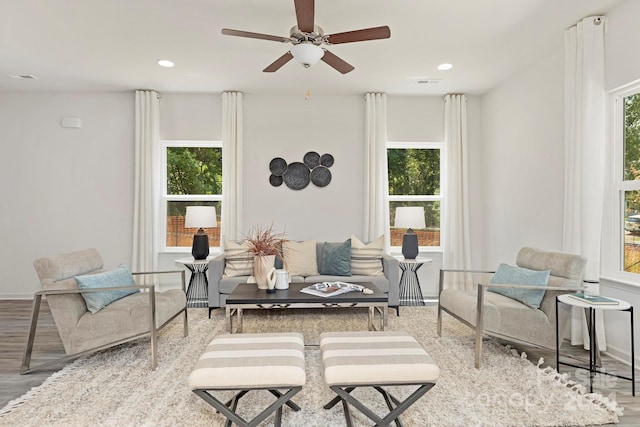 living area with hardwood / wood-style flooring, plenty of natural light, and ceiling fan