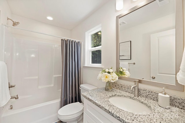 full bathroom featuring toilet, vanity, and shower / tub combo with curtain