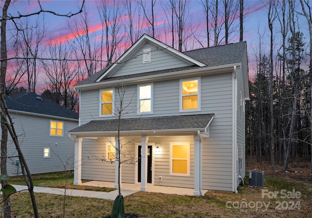 view of front facade with covered porch and cooling unit