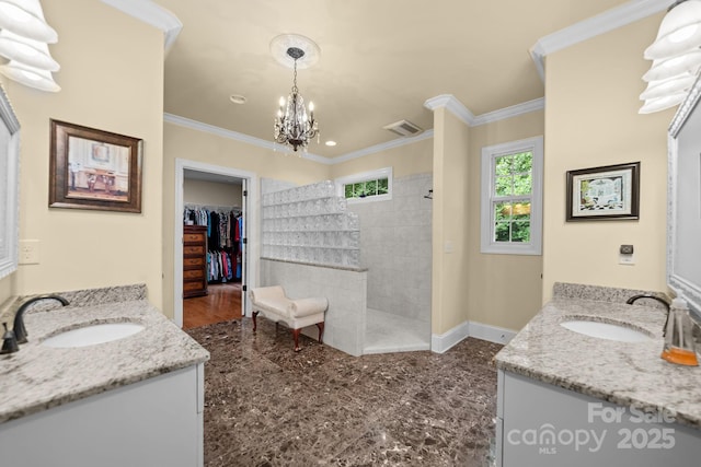 bathroom with a tile shower, crown molding, vanity, and a notable chandelier