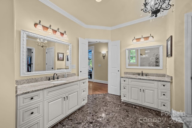 bathroom featuring a chandelier, vanity, plenty of natural light, and ornamental molding