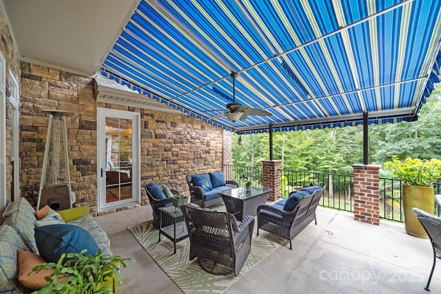 view of patio with outdoor lounge area and ceiling fan