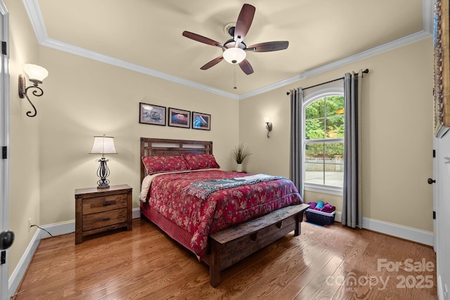 bedroom with ceiling fan, crown molding, and hardwood / wood-style flooring