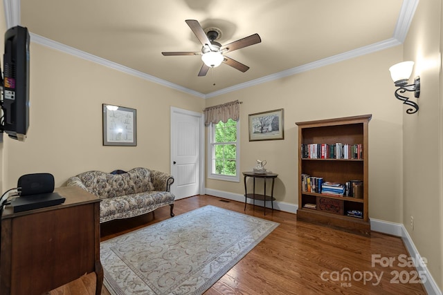 office area with ceiling fan, wood-type flooring, and ornamental molding