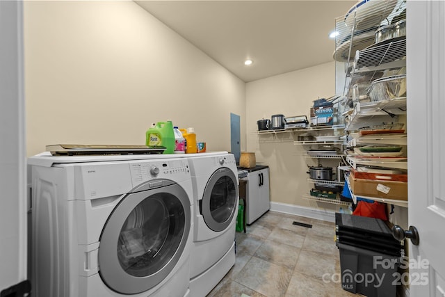 clothes washing area featuring washer and clothes dryer