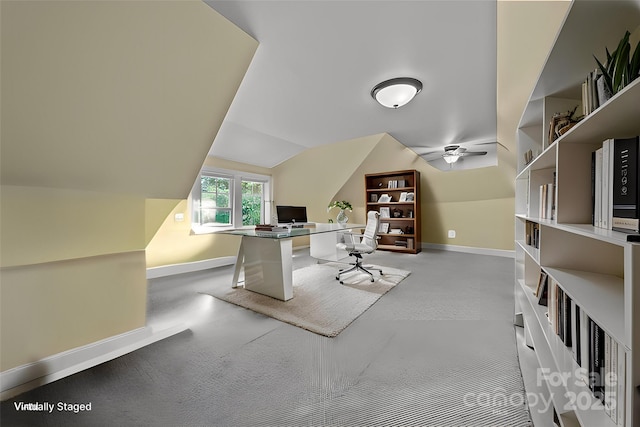 carpeted home office featuring vaulted ceiling and ceiling fan