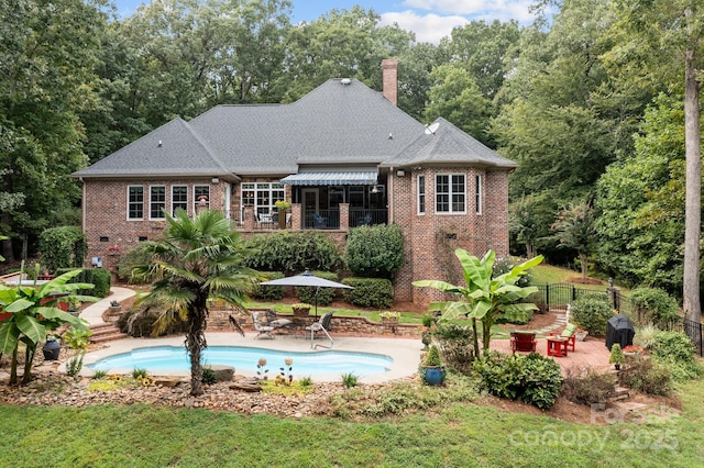 4364 Hager Mountain Ln, Iron Station, NC 28080 - rear view of property with brick siding, a patio, a chimney, fence, and a shingled roof