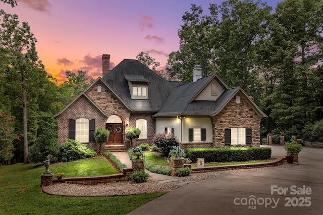 4364 Hager Mountain Ln, Iron Station, NC 28080 - view of front of house featuring a chimney, stucco siding, stone siding, and a front yard