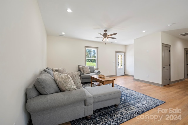 living area with recessed lighting, visible vents, a ceiling fan, wood finished floors, and baseboards