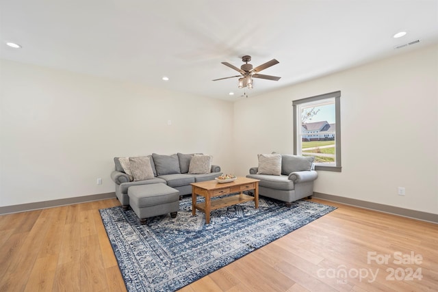 living area with baseboards, light wood-type flooring, visible vents, and recessed lighting