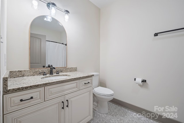 full bathroom featuring vanity, toilet, and tile patterned floors