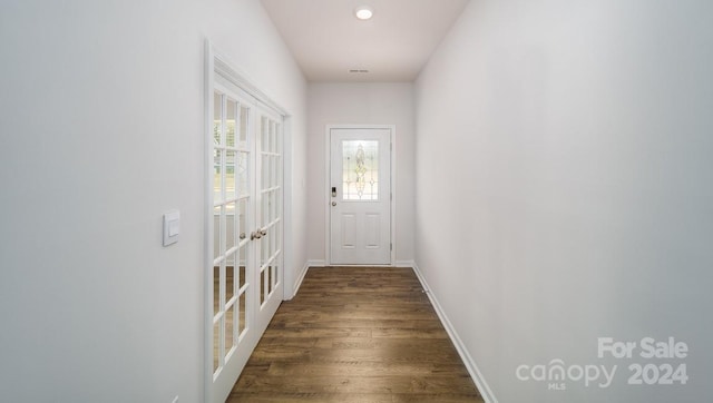 doorway with dark wood-type flooring and french doors