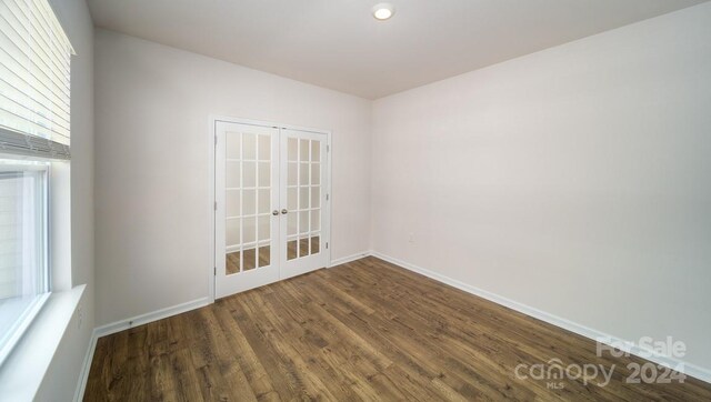 unfurnished room featuring french doors, wood-type flooring, and a healthy amount of sunlight