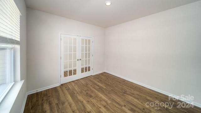 empty room with french doors and dark wood-type flooring