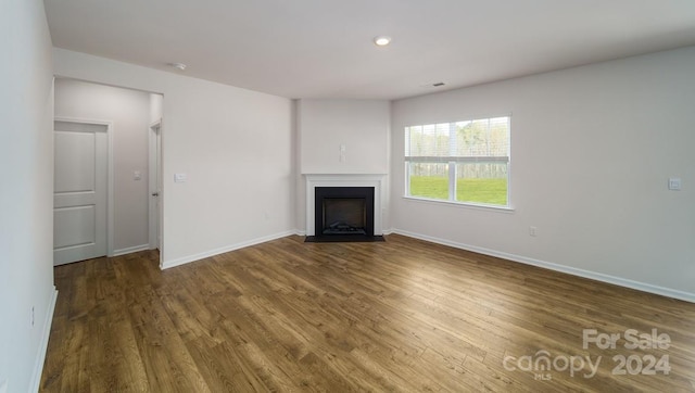 unfurnished living room with hardwood / wood-style floors