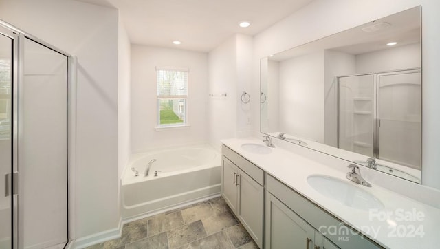 bathroom with dual bowl vanity, tile patterned floors, and plus walk in shower