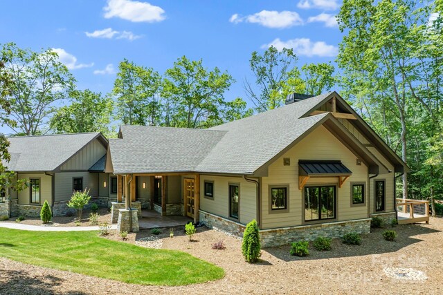 11 Nestlewood Dr Unit 310, Arden, NC 28704 - view of front of house with stone siding, roof with shingles, a porch, and a front yard