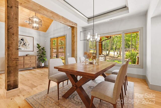 11 Nestlewood Dr Unit 310, Arden, NC 28704 - dining area with a chandelier, lofted ceiling, and light wood-type flooring