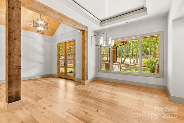11 Nestlewood Dr Unit 310, Arden, NC 28704 - unfurnished dining area featuring a chandelier, hardwood / wood-style flooring, and vaulted ceiling