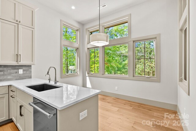 11 Nestlewood Dr Unit 310, Arden, NC 28704 - kitchen with stainless steel dishwasher, decorative backsplash, light stone countertops, light wood finished floors, and recessed lighting