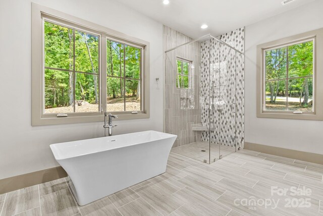 11 Nestlewood Dr Unit 310, Arden, NC 28704 - bathroom featuring a freestanding tub, a shower stall, and recessed lighting