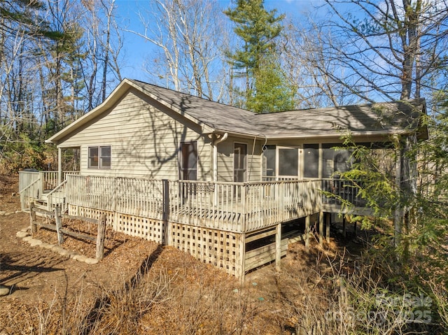 view of front of house featuring a wooden deck and a sunroom