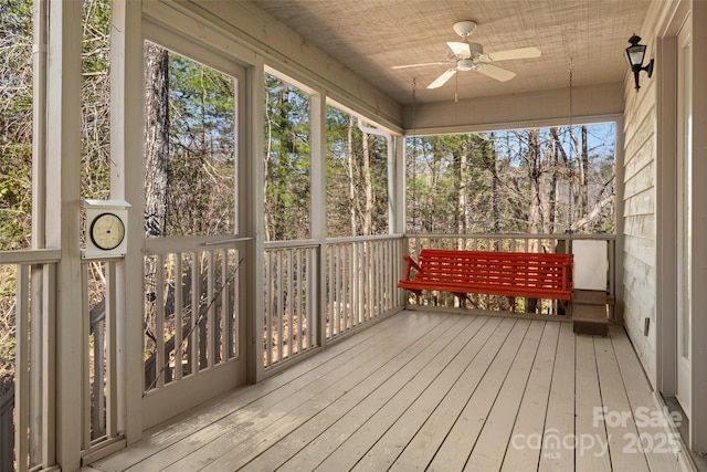 unfurnished sunroom featuring ceiling fan