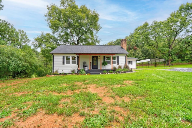 ranch-style home featuring covered porch, a carport, and a front yard