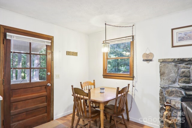 dining room featuring hardwood / wood-style flooring and a textured ceiling