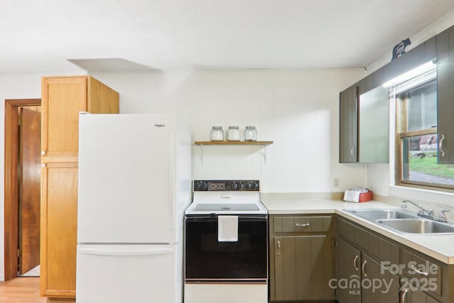 kitchen with white refrigerator, sink, and electric range