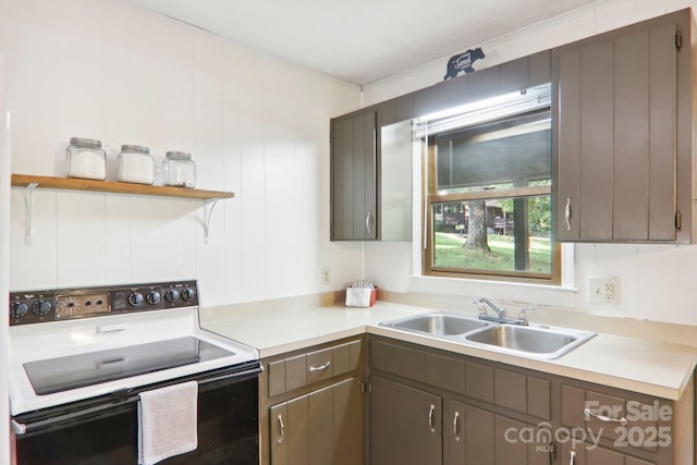 kitchen with black electric range and sink