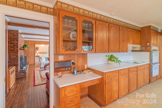 kitchen featuring light hardwood / wood-style flooring, ornamental molding, brick wall, beamed ceiling, and white appliances