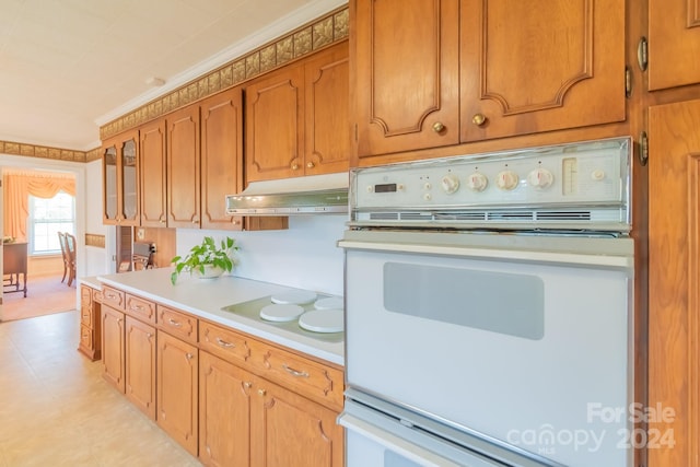 kitchen featuring white appliances and light tile patterned flooring