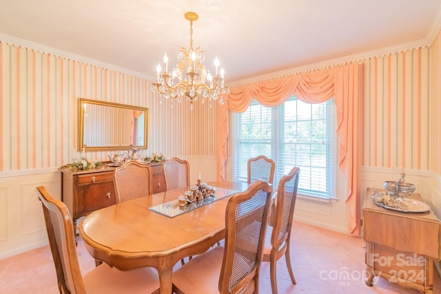 dining space featuring ornamental molding, an inviting chandelier, and light carpet