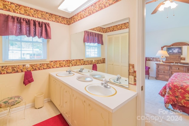 bathroom featuring ceiling fan, vanity, and a healthy amount of sunlight