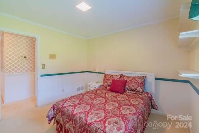 bedroom with carpet floors and ornamental molding