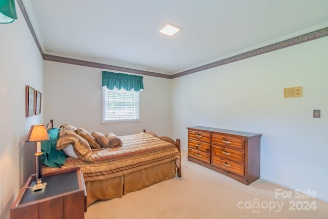 bedroom featuring light carpet and ornamental molding