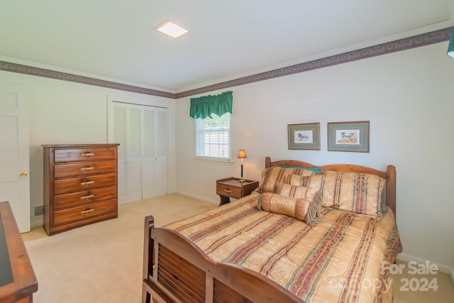 bedroom featuring baseboards, visible vents, light colored carpet, ornamental molding, and a closet