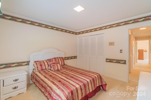 bedroom with a closet and light colored carpet