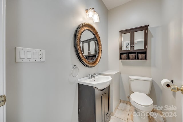 bathroom with vanity, toilet, and tile patterned flooring