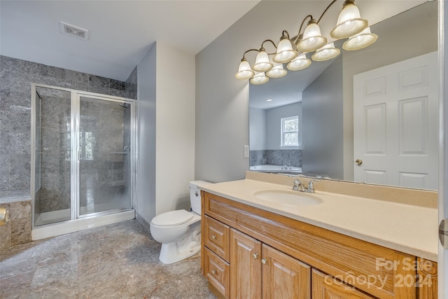 bathroom with an enclosed shower, toilet, vanity, and tile patterned flooring