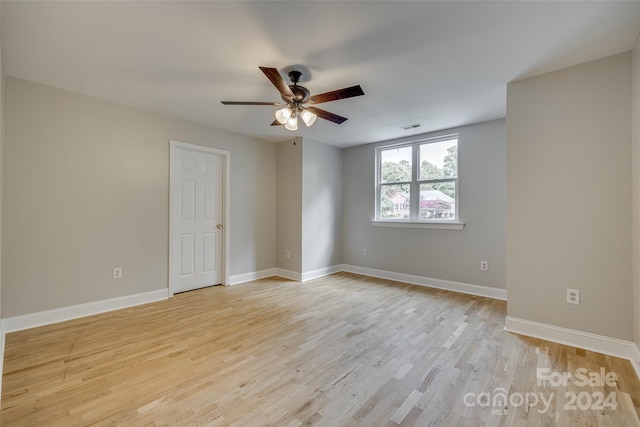 spare room featuring light hardwood / wood-style flooring and ceiling fan