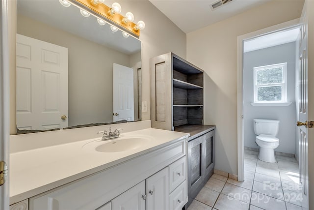 bathroom featuring tile patterned floors, vanity, and toilet