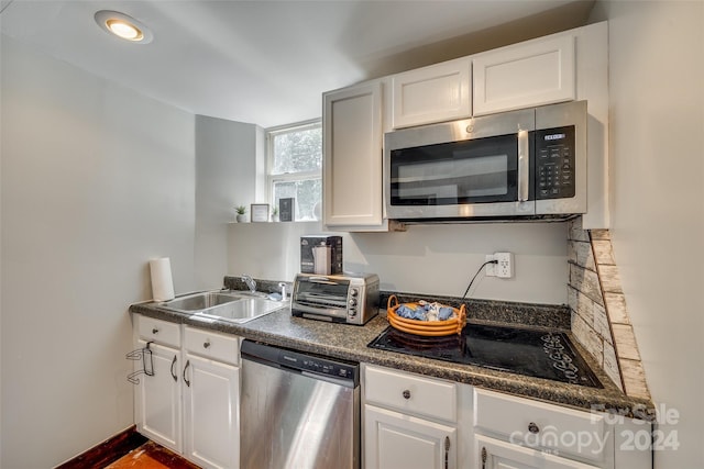 kitchen with white cabinets, stainless steel appliances, and sink