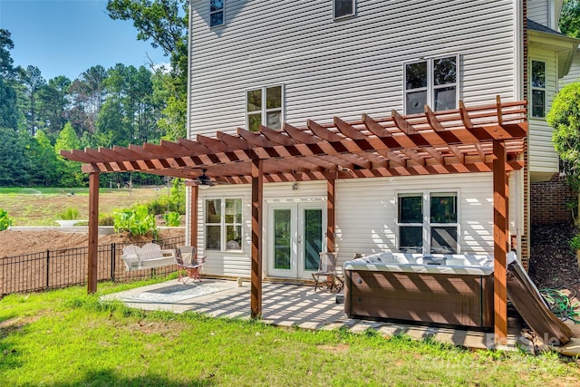 back of property with french doors, a pergola, a patio area, and a lawn