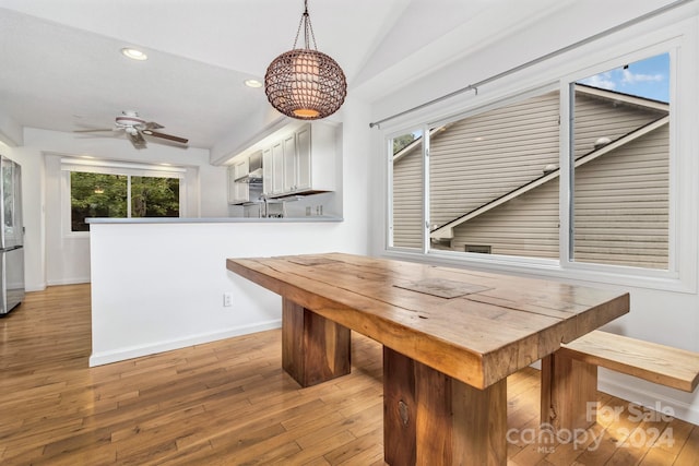 dining space with lofted ceiling, recessed lighting, ceiling fan, wood finished floors, and baseboards