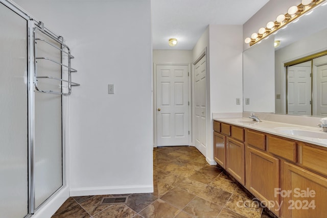 full bathroom featuring a closet, a sink, visible vents, and a shower stall