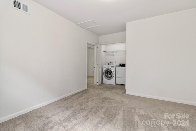 washroom with light carpet, laundry area, attic access, visible vents, and washer and dryer