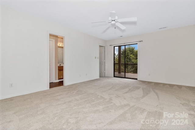 unfurnished room featuring ceiling fan, visible vents, baseboards, and light colored carpet